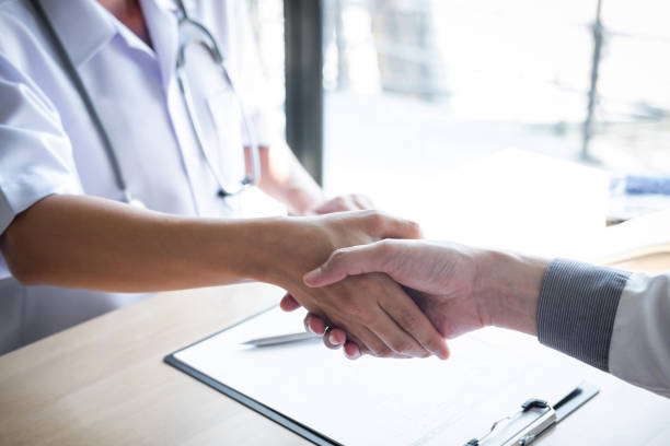 istock Doctor having shaking hands to congrats with patient after recommend treatment while discussing explaining his symptoms and counsel diagnosis health, healthcare and assistance concept 1144131028