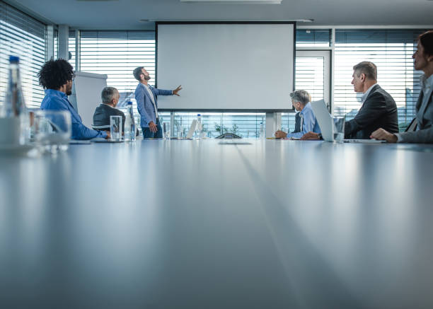 istock CEO giving a business presentation through projection screen in a board room. 1144131992