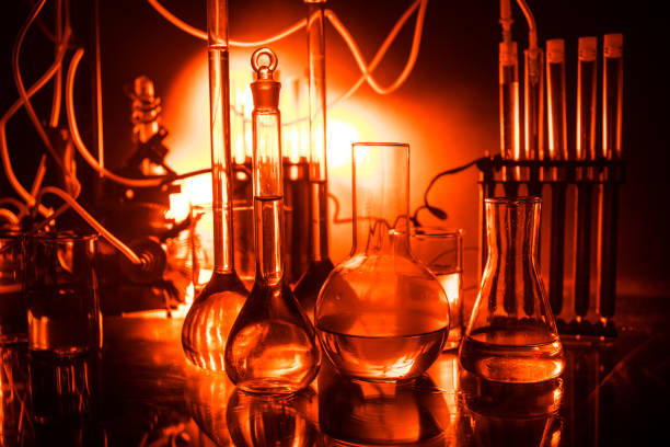 istock Pharmacy and chemistry theme. Test glass flask with solution in research laboratory. Science and medical background. Laboratory test tubes on dark toned background 1144132970
