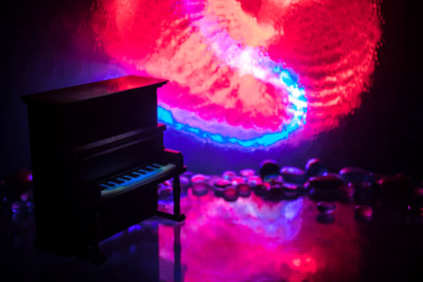 Creative concept. Artwork decoration with piano on dark toned foggy background with light. Selective focus
