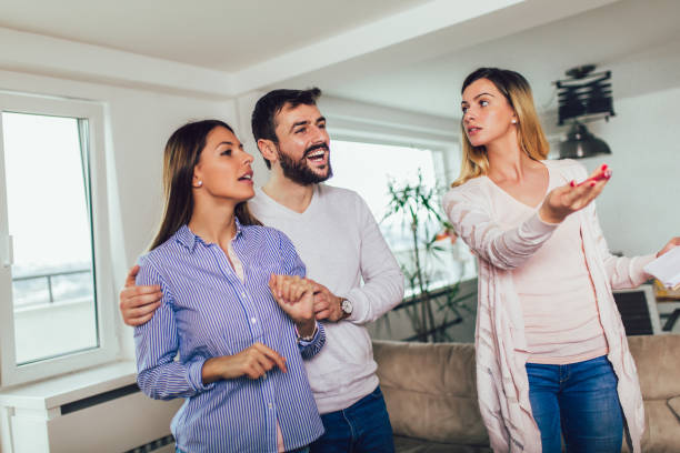 istock Real Estate agent shows interior to young couple 1144133216