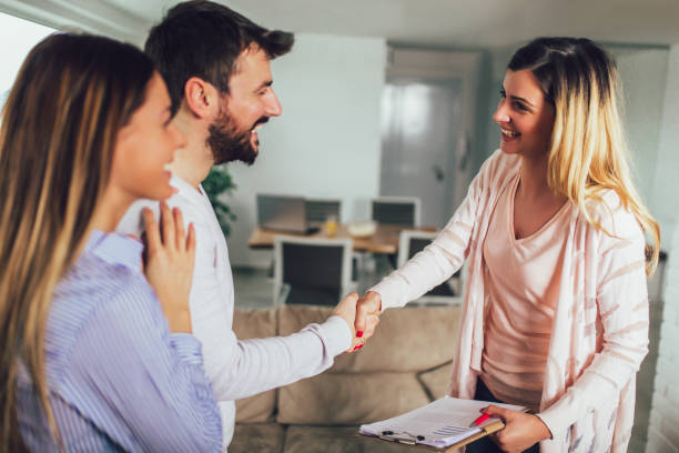 istock Real Estate agent shows interior to young couple 1144134073