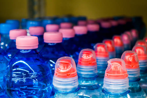 istock Lid plastic water bottle in the market. multi-colored plastic bottle caps 1144134411