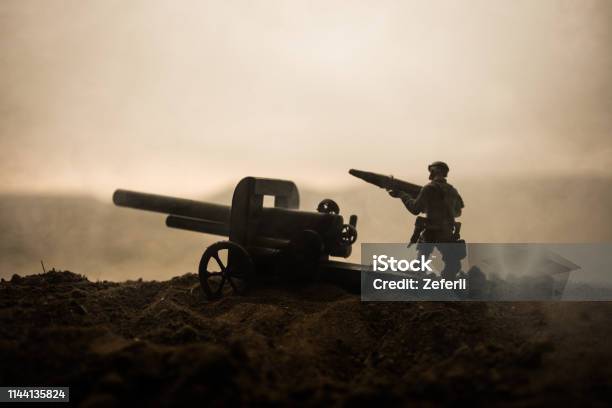 Battle Scene Silhouette Of Old Field Gun Standing At Field Ready To Fire With Colorful Dark Foggy Background Selective Focus Stock Photo - Download Image Now