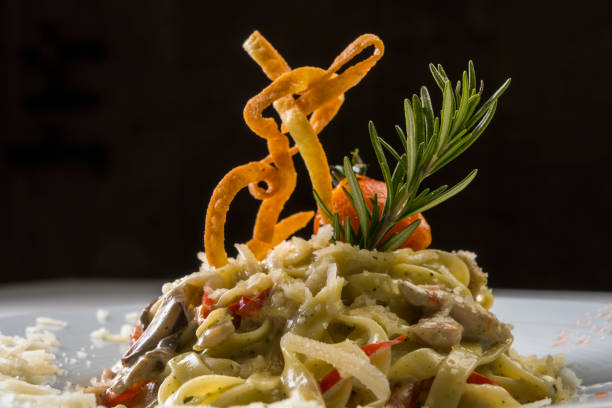 Red sauce pasta with bell peppers. Homemade Fusilli Pasta with Arrabbiata sauce. Photographed on white background.