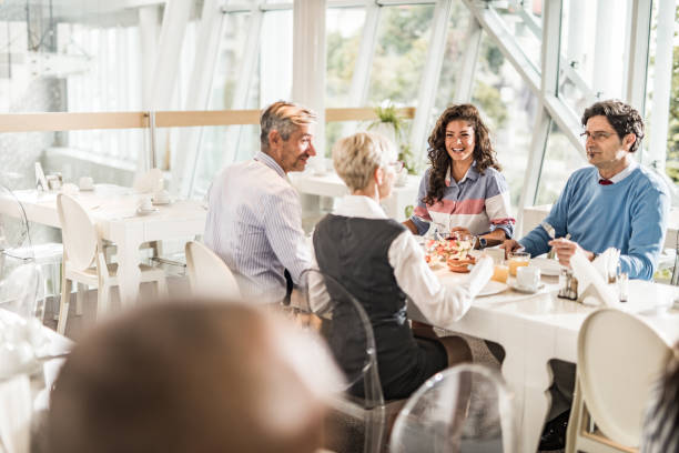istock Happy business colleagues talking on a lunch break in cafeteria. 1144138235