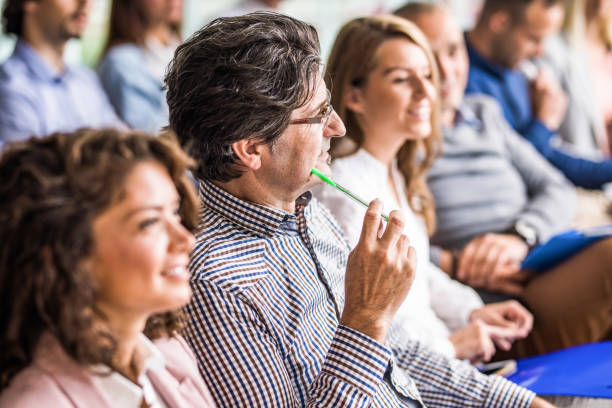 istock Thoughtful businessman on a seminar with his colleagues. 1144138274