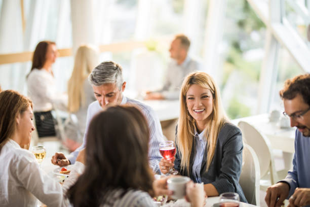 istock Group of happy business people communicating while having lunch break in cafeteria. 1144138970