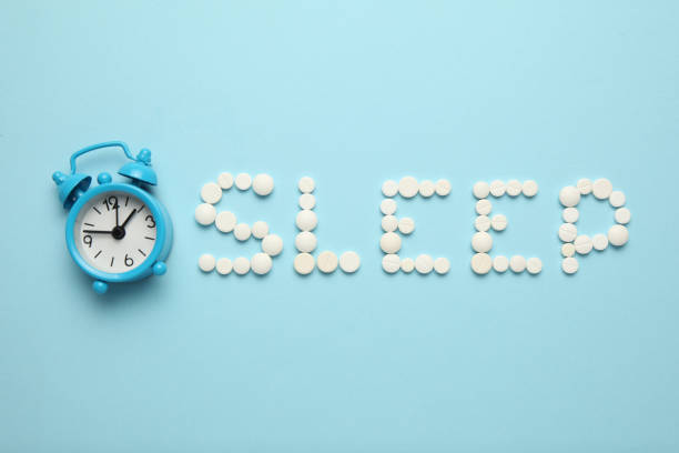 istock Sleeping pills and an alarm clock, insomnia concept. Nightmares and sleep disturbance 1144139577