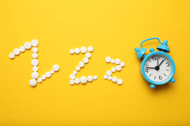 istock Sleeping pills and an alarm clock, insomnia concept. Medications for fatigue and sleep problems 1144139583