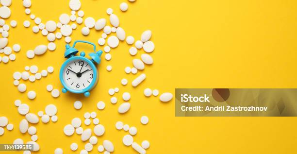 Sleeping Pills And An Alarm Clock Insomnia Concept Trouble Falling Asleep Stock Photo - Download Image Now