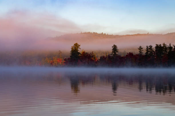 Chocorua Lake on an Autumn morning as fog lifts.