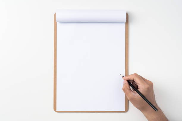 white paper on clipboard with mans hand