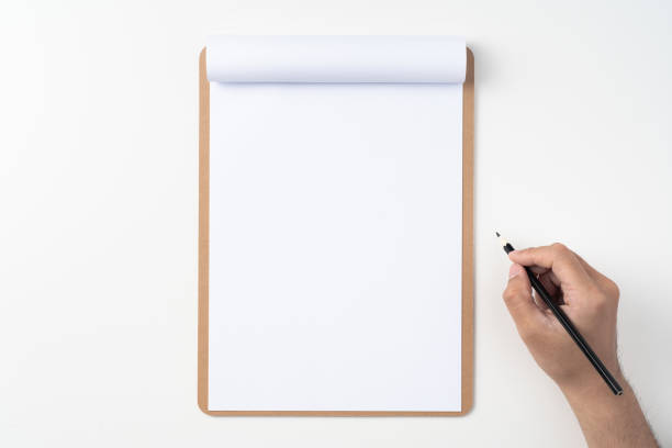 istock white paper on clipboard with mans hand 1144144269
