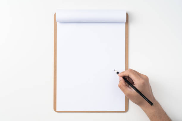 istock white paper on clipboard with mans hand 1144144273