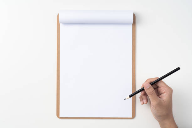 istock white paper on clipboard with mans hand 1144144276