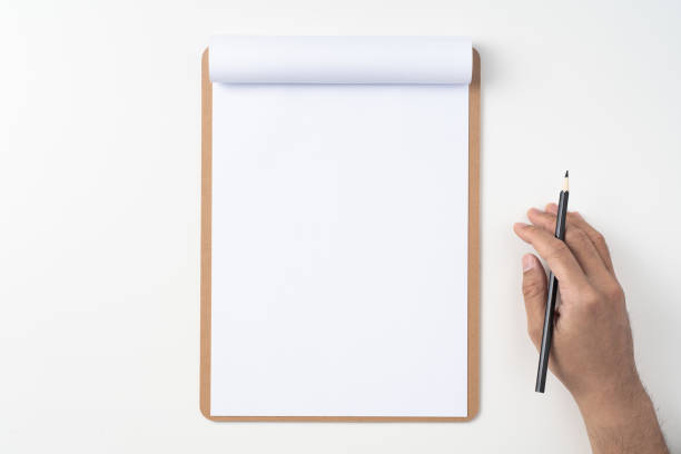 istock white paper on clipboard with mans hand 1144144280