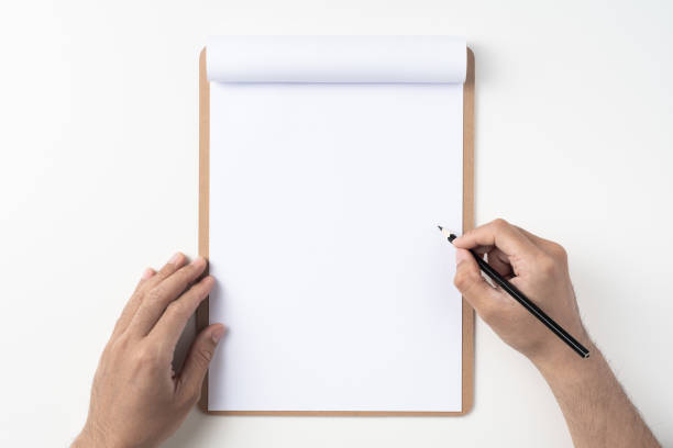 istock white paper on clipboard with mans hand 1144144290