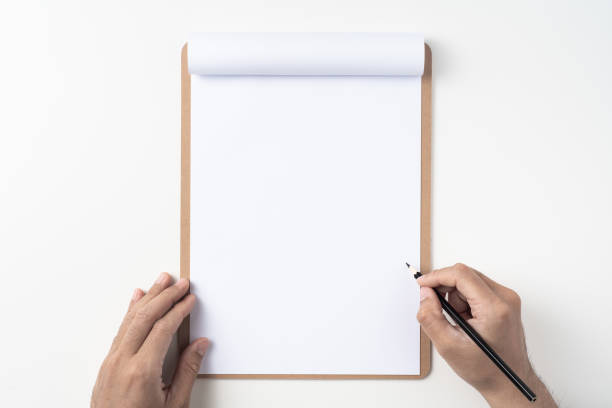 istock white paper on clipboard with mans hand 1144144296