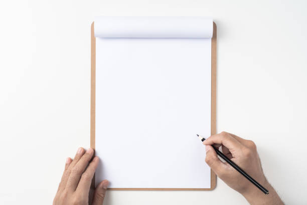 istock white paper on clipboard with mans hand 1144144300
