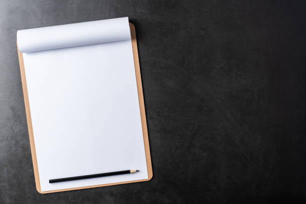 istock white paper with clipboard on black stone background 1144144381