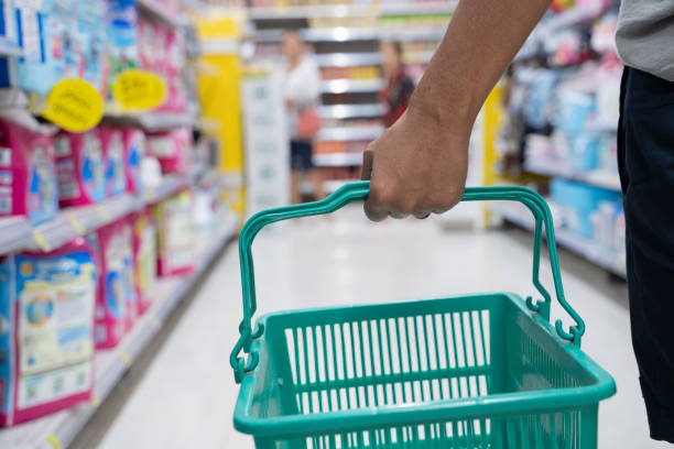 Asian man shopping in kid section at supermarket. - Image
