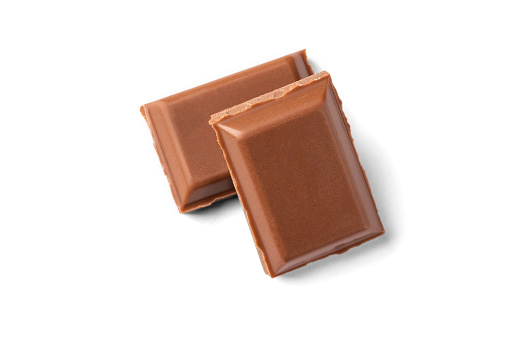 Two slices of milk chocolate. One is on the other