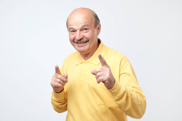 istock Amazed senior man has excited expression, index finger up, recieve good idea 1144149166