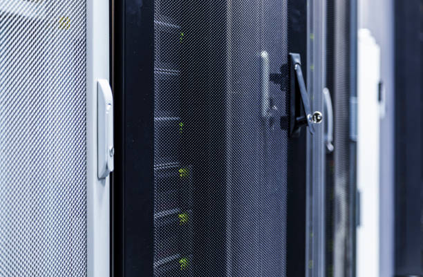 istock Close up view grid door with key of modern mainframe in high tech internet data center abstract . Depth of field, selective focus 1144149579