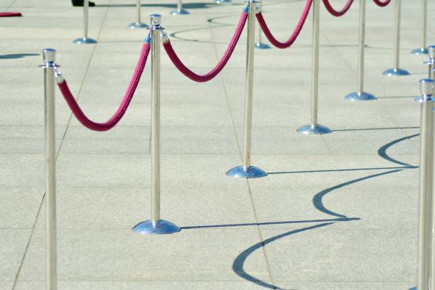 istock Silver stanchions with a purple rope 1144151989