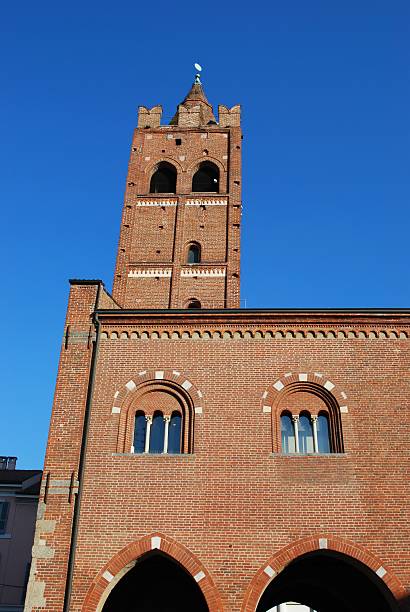 Asmara, Eritrea: free standing clock / bell tower of the Church of Our Lady of the Rosary (1923), usually called 'the cathedral', contains eight bells cast in Padua by the Colbachini papal foundry from bronze of Austro-Hungarian guns captured in WWI, these were a gift of Luigi Federzoni, Minister of the colonies and were installed only in 1925 - Lombard Romanesque style, with intricate brick masonry work and an octagonal pyramid roof - designed by Oreste Scanavini from Milan - Harnet Avenue, the colonial Viale Mussolini - at over 50 meters high, the bell tower is the tallest structure in the city - Asmera, a Modernist City of Africa, UNESCO World Heritage Site - Chiesa della Beata Vergine del Rosario.