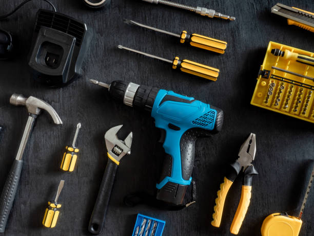 istock top view of Construction tools concept with Drill sets, hammer, screwdriver and Toolbox on black wooden background. 1144153168