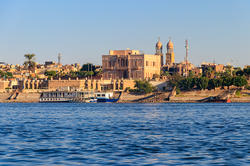 Cityscape of Luxor temple at sunset seen from Nile river