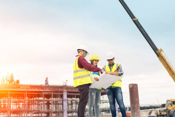 istock Architect and engineer meeting planning for a new project with construction equipment 1144155309