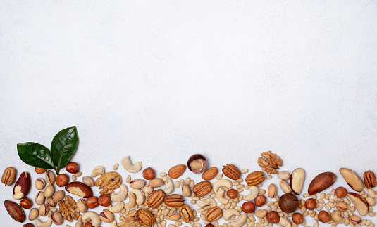 mix of nuts on a light background. view from above. banner. copy space