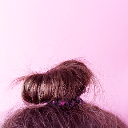 Modern hairstyle bun on a white background, copy space