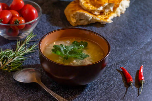 istock Light soup in chicken broth, with noodles and spices on a dark background. Horizontal orientation 1144160945
