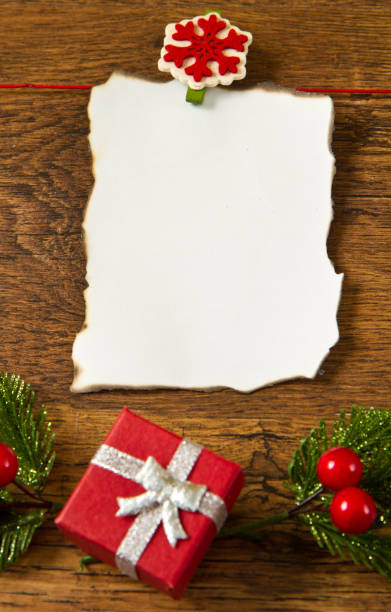 istock blank note with christmas decoration on wooden background 1144161666