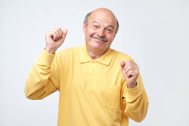 istock Mature happy man moving dancing over white background. 1144162970