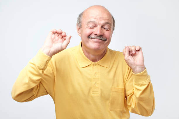 istock Mature happy man moving dancing over white background. 1144162982
