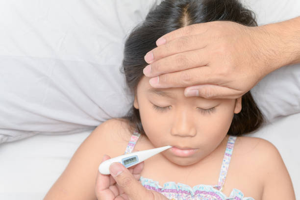 istock Father measuring temperature of ill kid. 1144169230