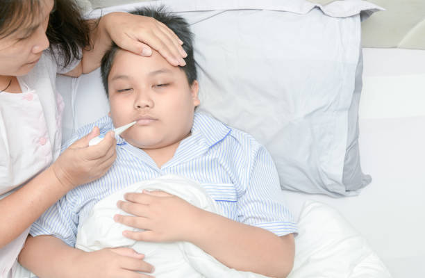 istock Mother measuring temperature of ill kid. 1144169404