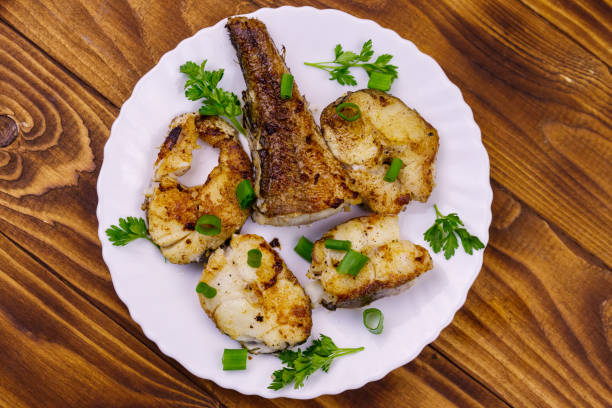 istock Roasted pollock in white plate on a wooden table 1144169693