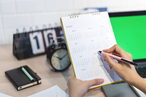 Woman planning agenda and schedule using calendar event planner. Calender planner organization management remind concept.