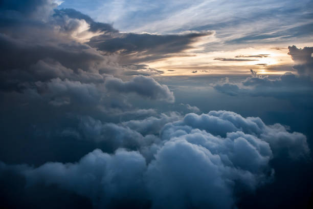 istock Aerial view of a cloudy sunset while flying above the clouds 1144170344