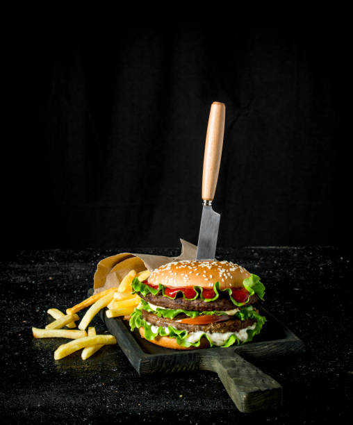 istock Burger with a knife and fries. 1144170635