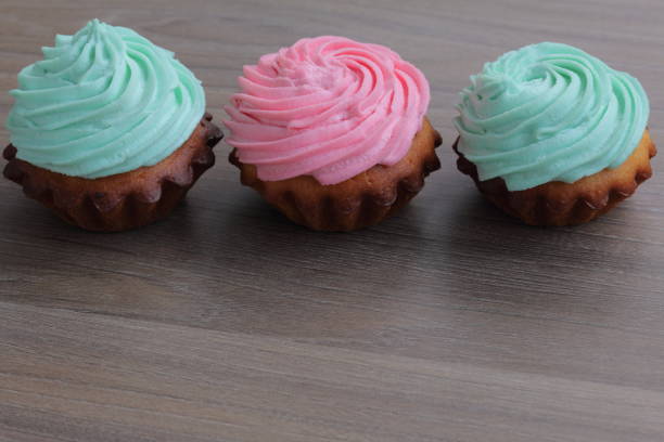 istock Three cream cakes of different colors. Stand in a row. 1144172103