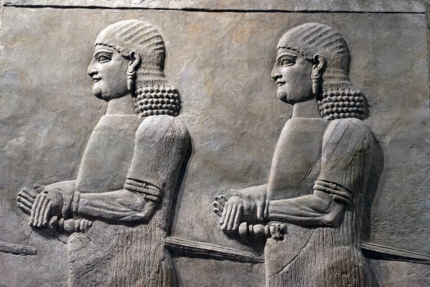 Assyrian wall relief of a genius from Mesopotamia, detail with a head. Ancient carving panel from the Middle East history.