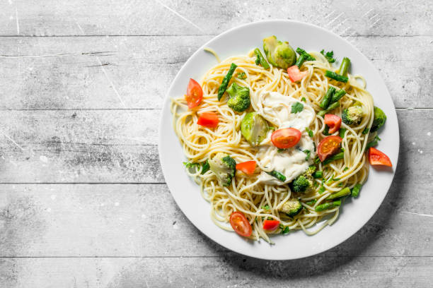 istock Pasta with vegetables and sauce on a plate. 1144172508