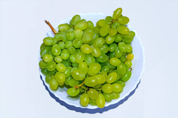 istock Fresh green and Yellowish grapes in a ceramic bowl on white background. 1144172776
